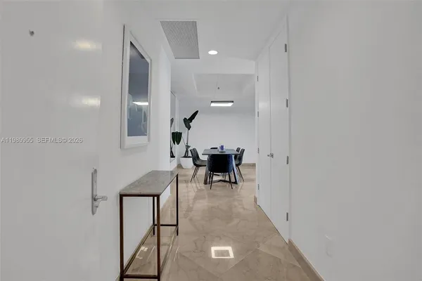 a view of a livingroom and a dining room with furniture