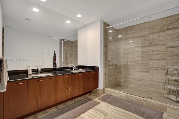 a view of a bathroom with a shower and a sink