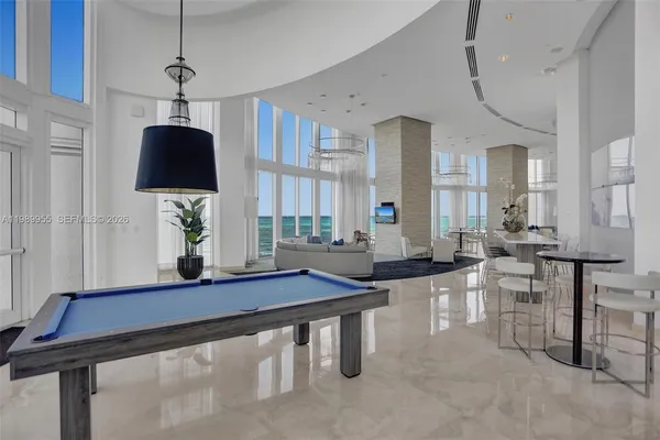 a living room with furniture a window and a chandelier