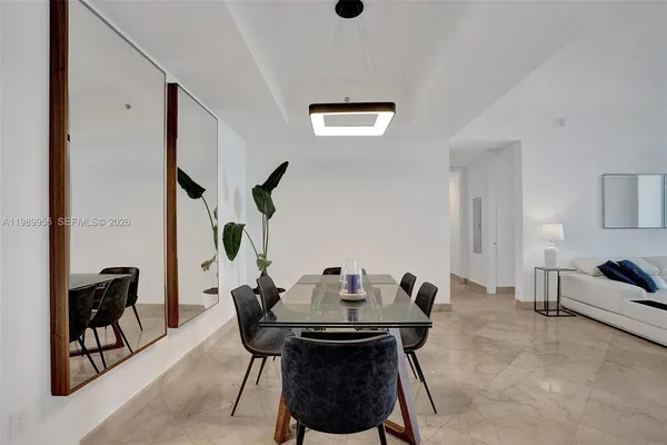 a view of a dining room with furniture and a potted plant