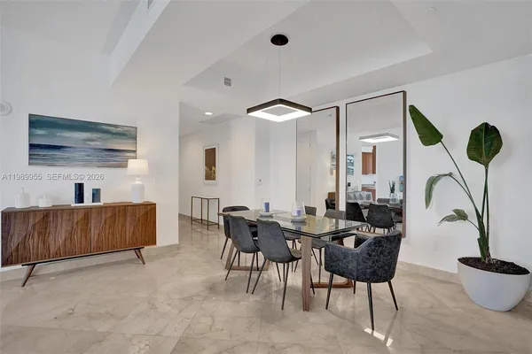 a dining room with furniture and wooden floor
