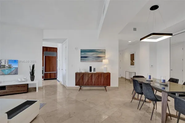 a living room with furniture and a air conditioner vent