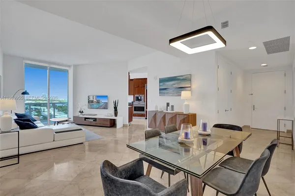 a view of a livingroom with furniture and a dining table