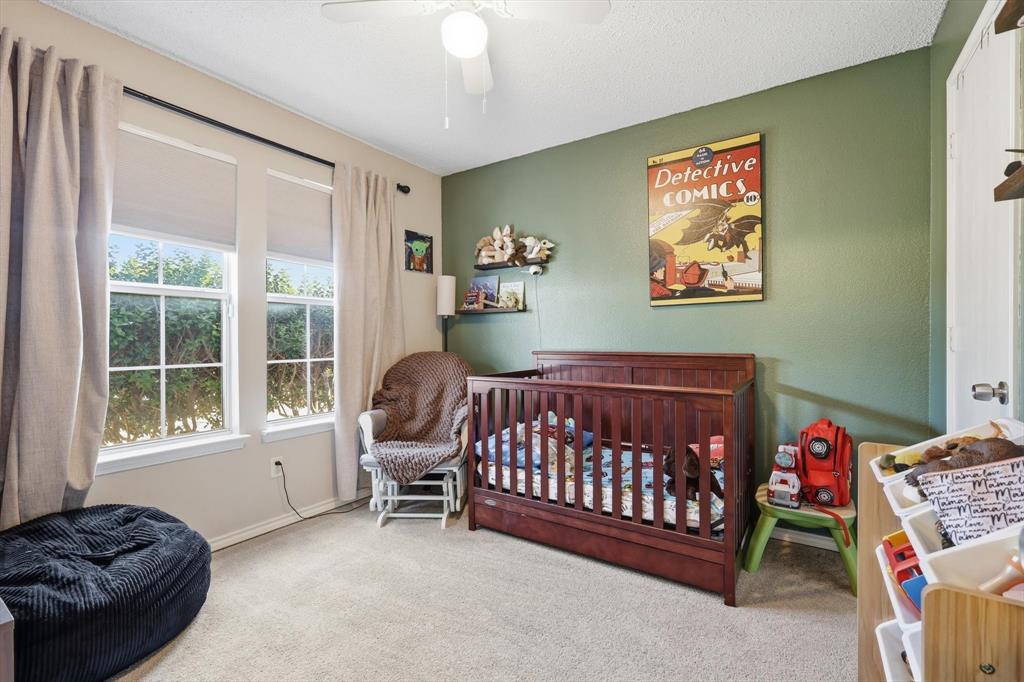 205 Comanche Trail Krum, TX 76249 - Photo 12 of 24 a bedroom with a bed and a window