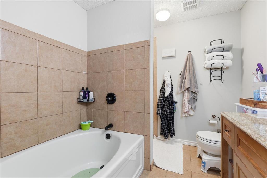 205 Comanche Trail Krum, TX 76249 - Photo 17 of 24 a bathroom with a sink a toilet and shower