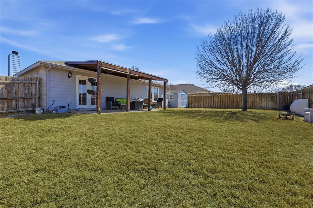 205 Comanche Trail Krum, TX 76249 - Photo 22 of 24 a front view of house with yard and trees