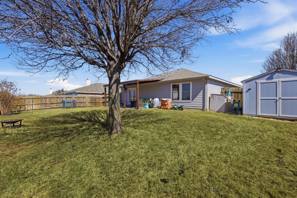 205 Comanche Trail Krum, TX 76249 - Photo 23 of 24 a front view of a house with garden