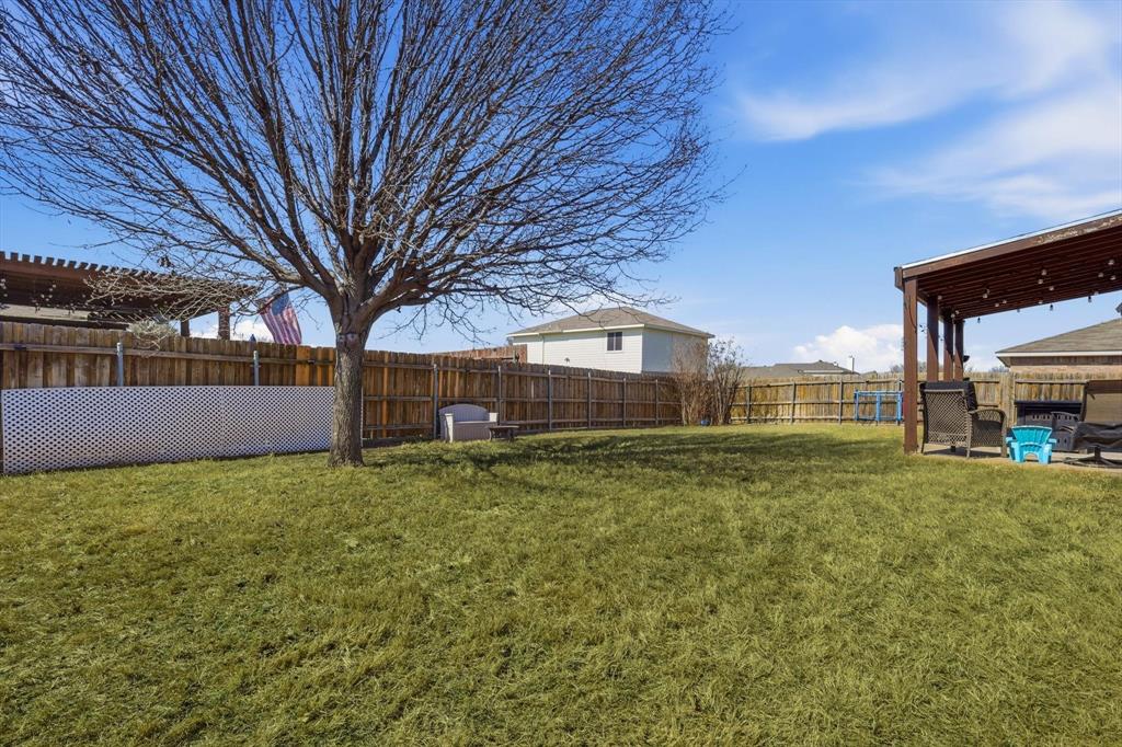 205 Comanche Trail Krum, TX 76249 - Photo 24 of 24 a house view with a garden space