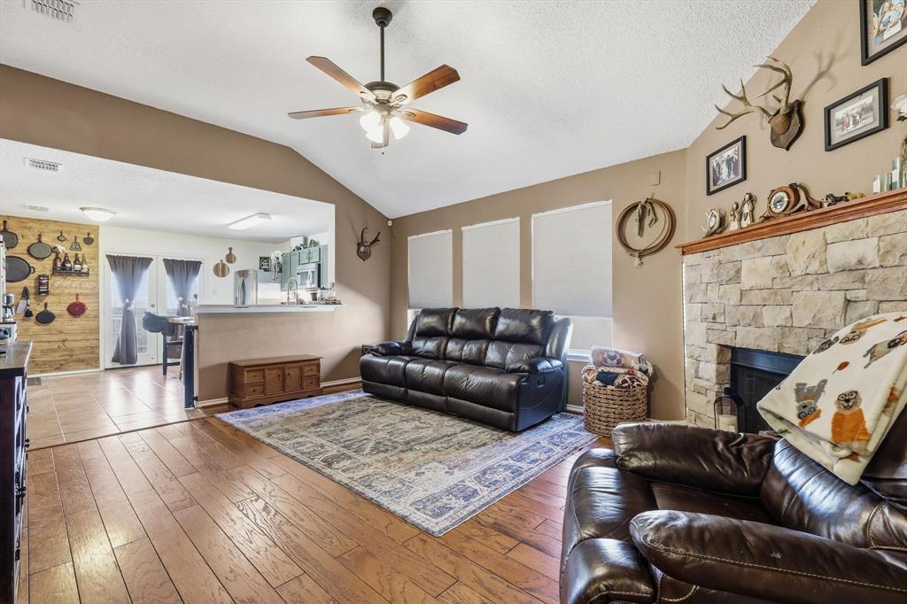 205 Comanche Trail Krum, TX 76249 - Photo 5 of 24 a living room with furniture and a fireplace