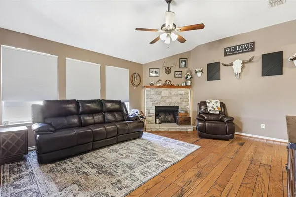 a living room with furniture and a fireplace