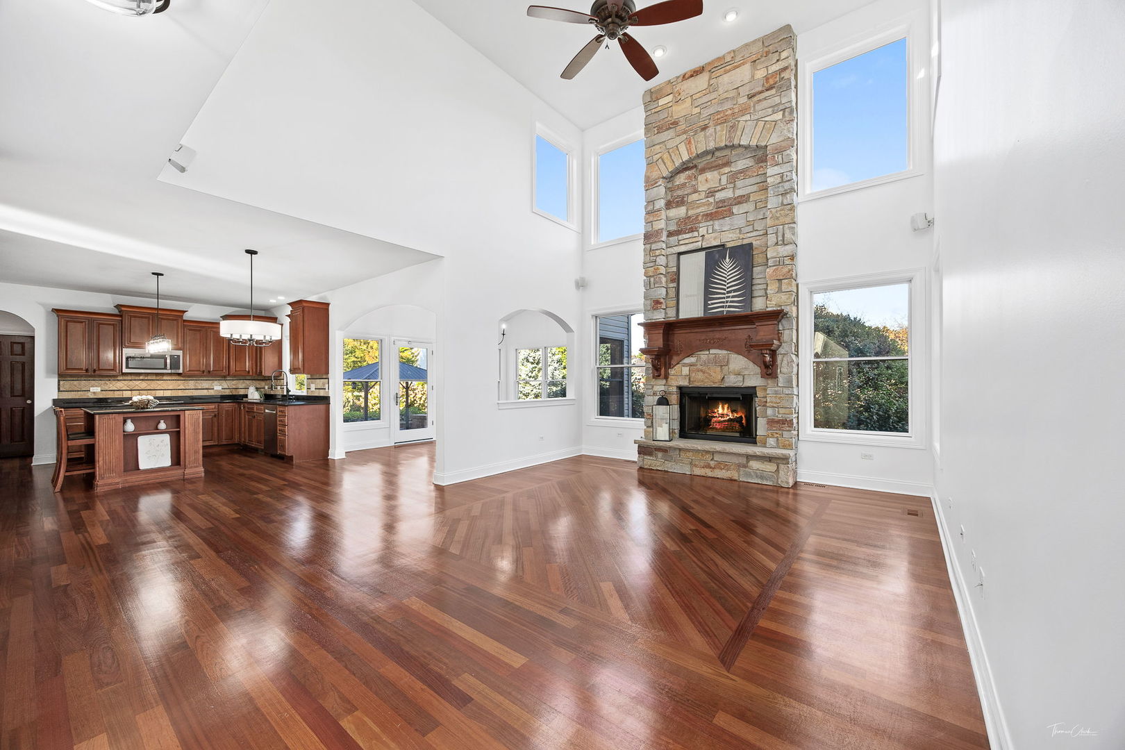 12929 Alpine Way Plainfield, IL 60585 - Photo 19 of 55 a view of an empty room with wooden floor fireplace and a window
