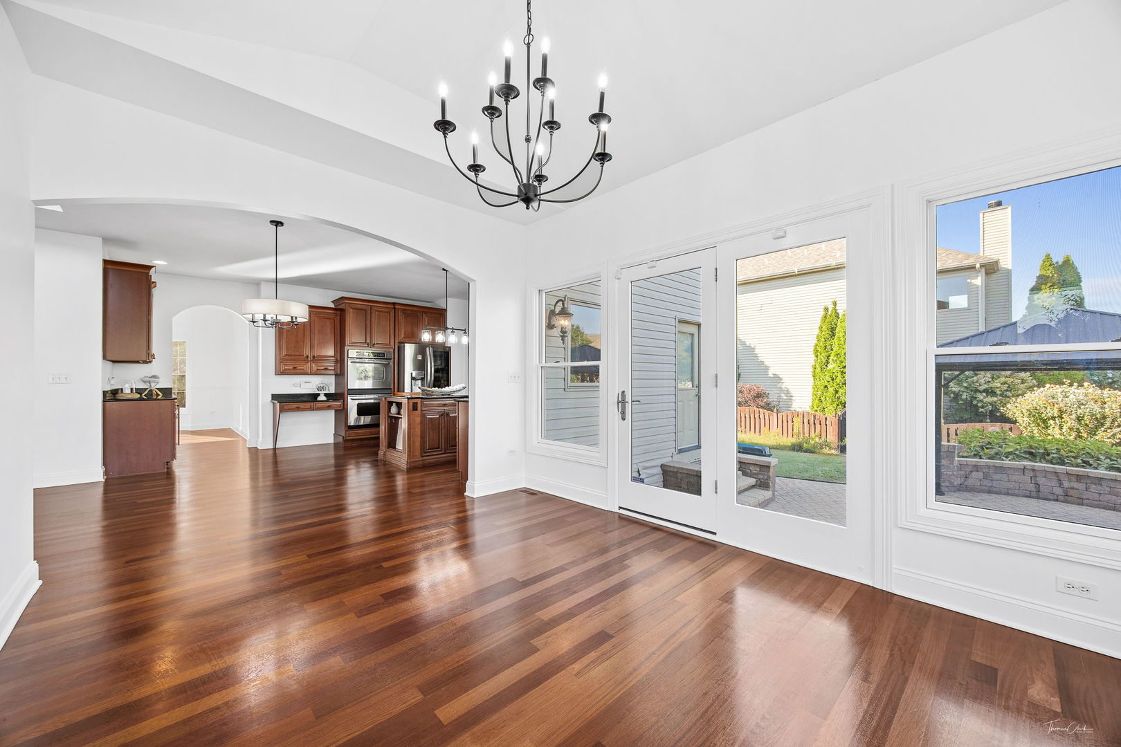 12929 Alpine Way Plainfield, IL 60585 - Photo 22 of 55 a view of empty room with wooden floor and windows