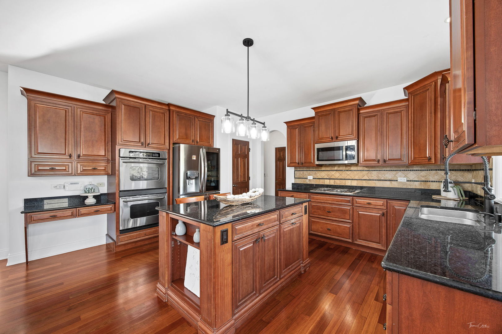 12929 Alpine Way Plainfield, IL 60585 - Photo 26 of 55 a kitchen with stainless steel appliances granite countertop a stove refrigerator and cabinets