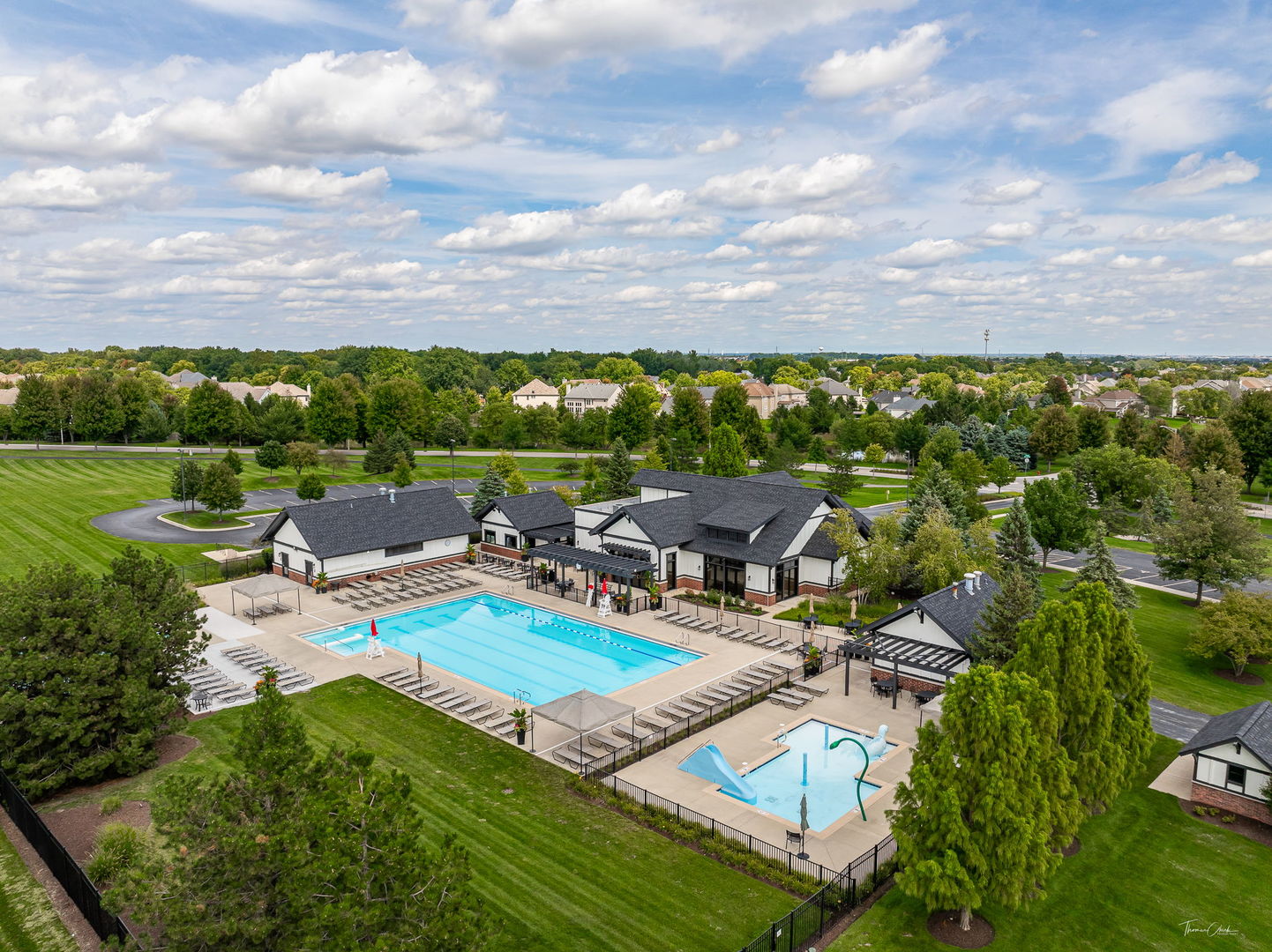 12929 Alpine Way Plainfield, IL 60585 - Photo 54 of 55 a view of swimming pool with seating area and trees in the background