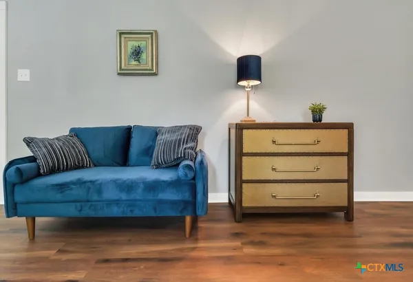 a living room with furniture and a wooden floor