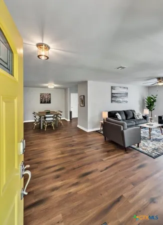 a view of a livingroom with furniture nad wooden floor