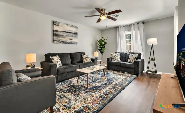 a living room with furniture and a large window