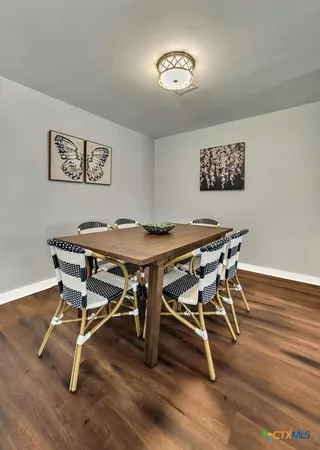 a view of a room with furniture and wooden floor