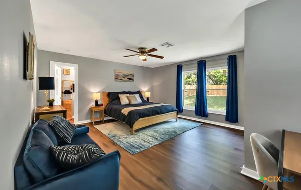 a bedroom with a bed couch and a window