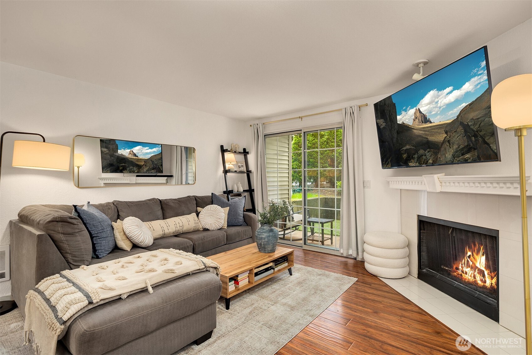 215 9th Street, Unit D102 Kirkland, WA 98033 - Photo 1 of 29 a living room with furniture a flat screen tv and a fireplace
