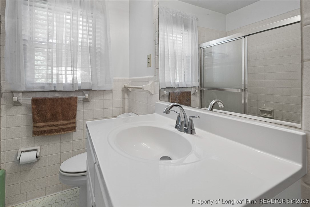 613 East 3rd Avenue Red Springs, NC 28377 - Photo 13 of 37 a bathroom with a sink and a toilet