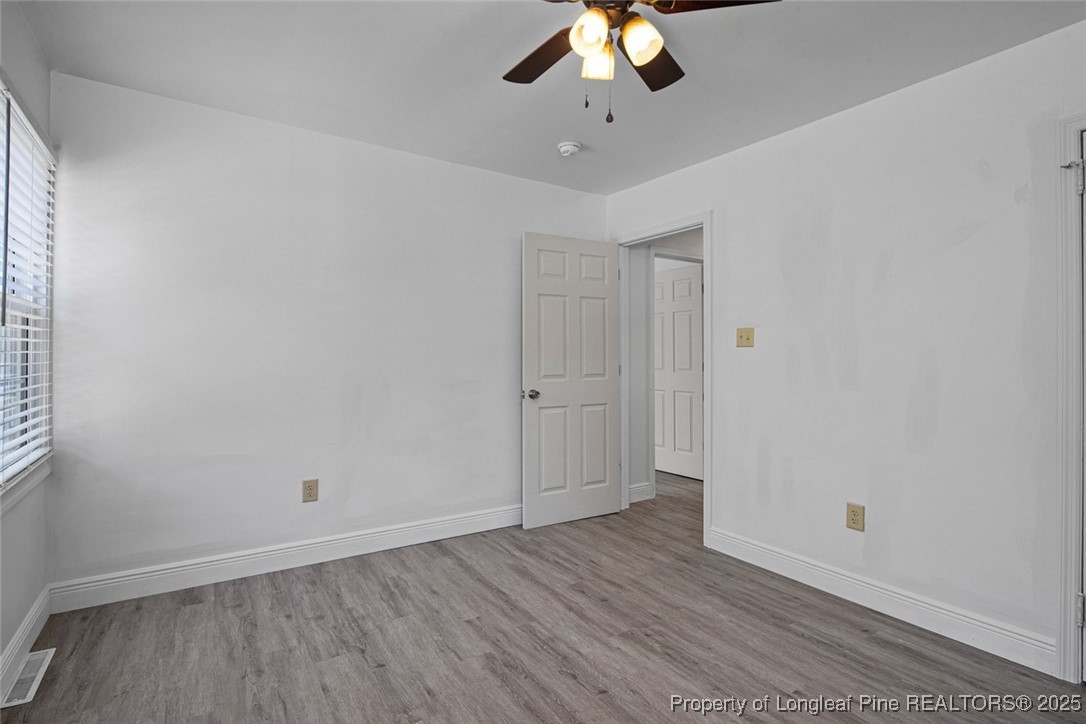 613 East 3rd Avenue Red Springs, NC 28377 - Photo 16 of 37 wooden floor in an empty room
