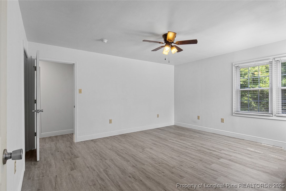 613 East 3rd Avenue Red Springs, NC 28377 - Photo 19 of 37 wooden floor in an empty room with a window