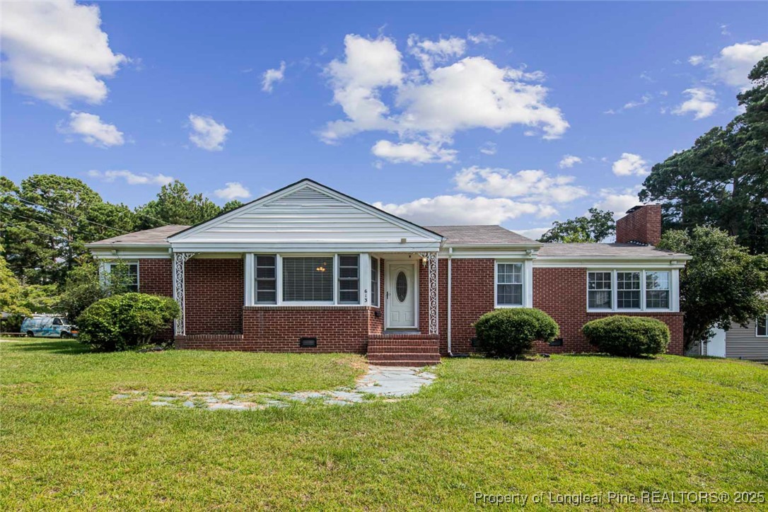 613 East 3rd Avenue Red Springs, NC 28377 - Photo 2 of 37 a front view of a house with a garden