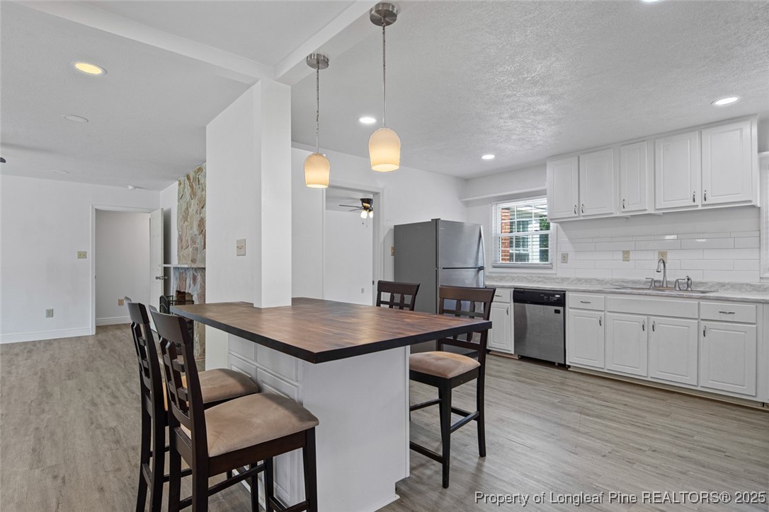 613 East 3rd Avenue Red Springs, NC 28377 - Photo 24 of 37 a kitchen with a table chairs stove and microwave