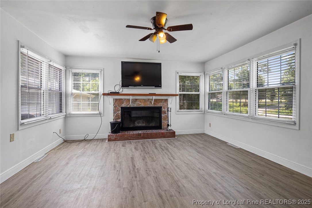 613 East 3rd Avenue Red Springs, NC 28377 - Photo 28 of 37 a view of an empty room with wooden floor and a fireplace