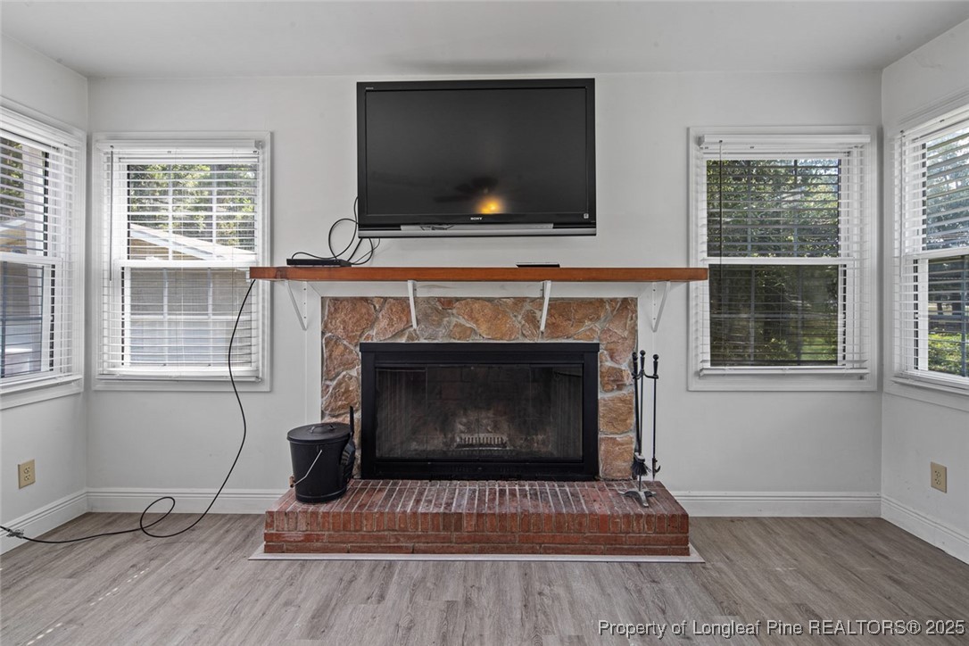 613 East 3rd Avenue Red Springs, NC 28377 - Photo 29 of 37 a living room with a fireplace a flat screen tv and a large window
