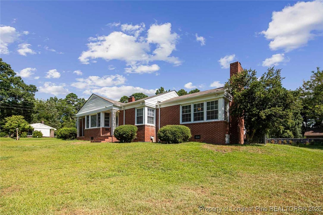 613 East 3rd Avenue Red Springs, NC 28377 - Photo 3 of 37 a front view of a house with a yard