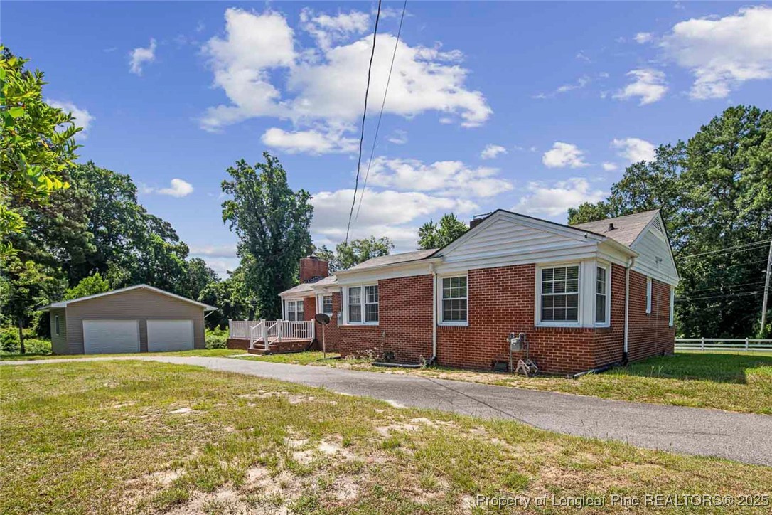 613 East 3rd Avenue Red Springs, NC 28377 - Photo 36 of 37 a front view of a house with garden