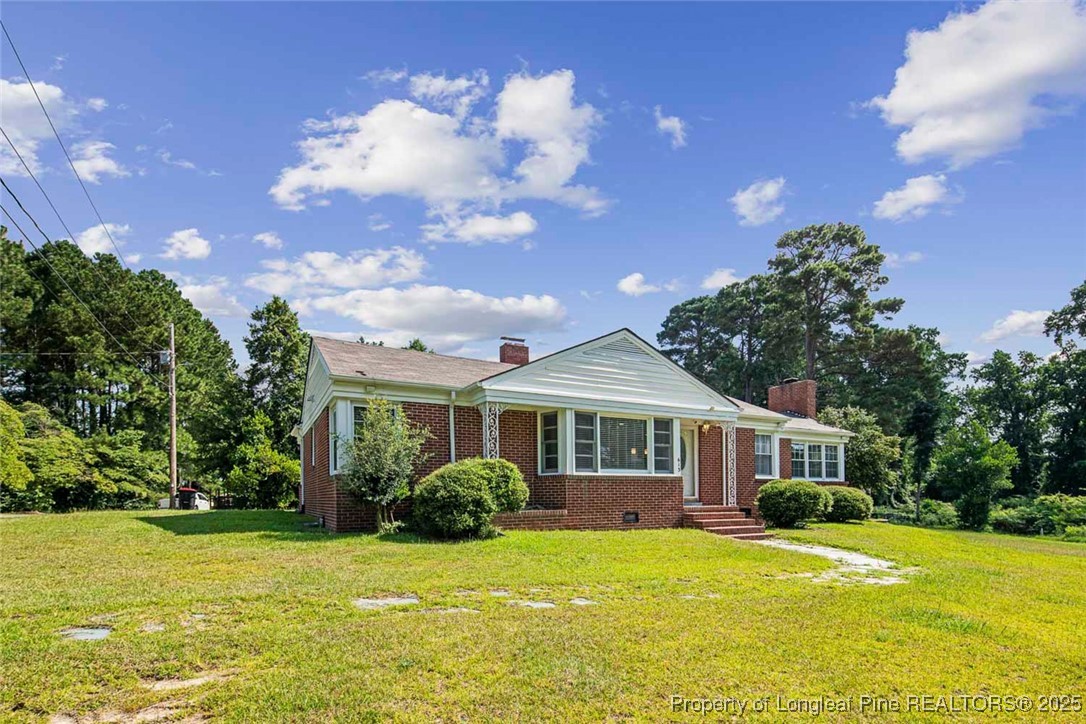 613 East 3rd Avenue Red Springs, NC 28377 - Photo 4 of 37 a front view of a house with a yard