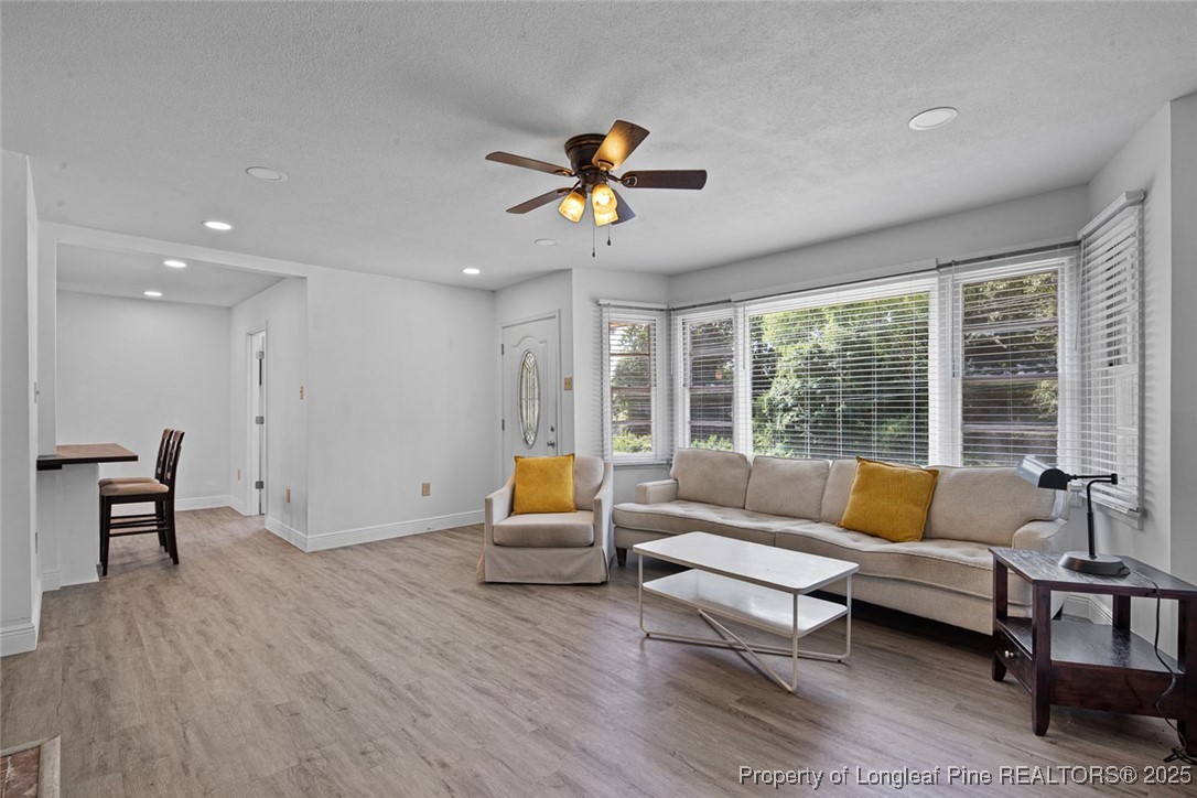 613 East 3rd Avenue Red Springs, NC 28377 - Photo 6 of 37 a living room with furniture and a dining table with wooden floor