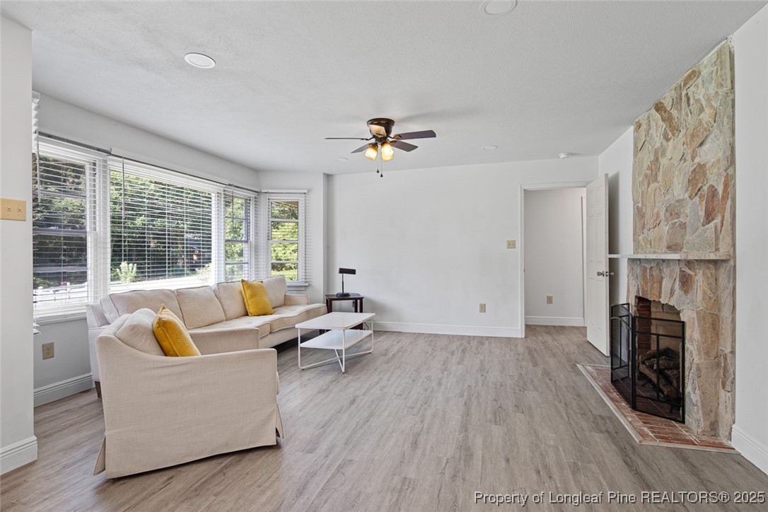 613 East 3rd Avenue Red Springs, NC 28377 - Photo 7 of 37 a living room with furniture and a fireplace