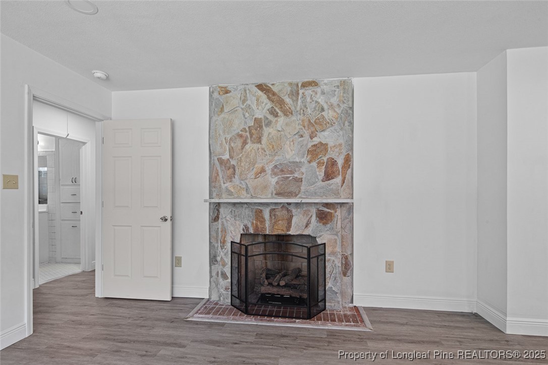 613 East 3rd Avenue Red Springs, NC 28377 - Photo 8 of 37 a room with a fireplace and a painting on the wall