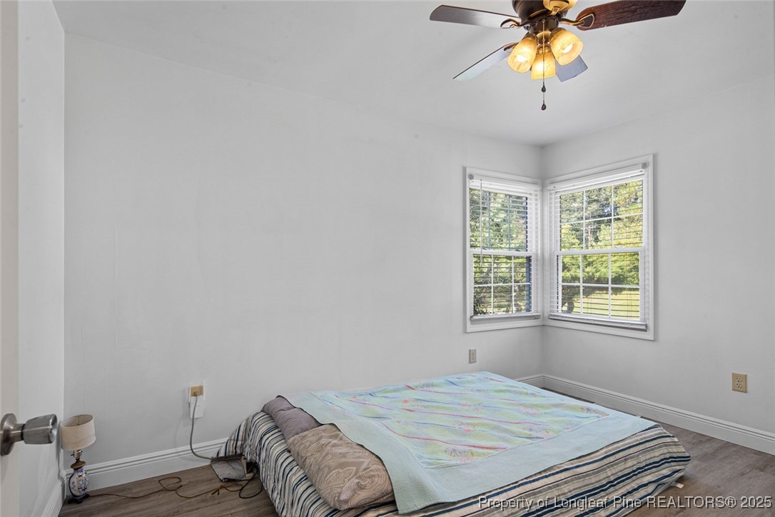 613 East 3rd Avenue Red Springs, NC 28377 - Photo 9 of 37 a bedroom with a bed and a chandelier