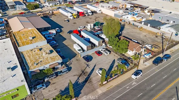 an aerial view of residential building with parking