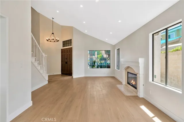 a view of an empty room with a fireplace and a window
