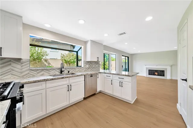 a large white kitchen with a large window