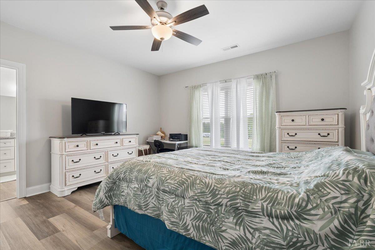 578 Collins Ferry Road Gladys, VA 24554 - Photo 12 of 36 a bedroom with a bed and a flat screen tv