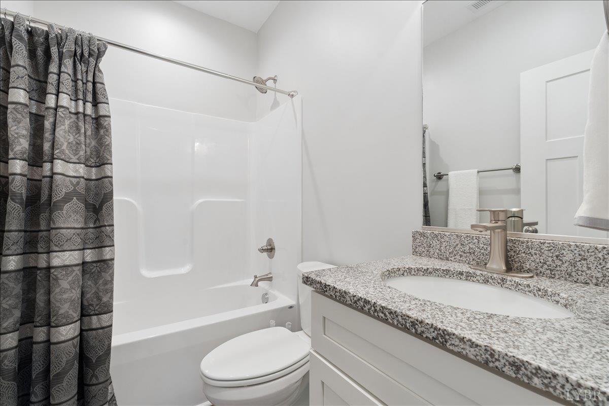 578 Collins Ferry Road Gladys, VA 24554 - Photo 14 of 36 a bathroom with a granite countertop sink toilet and shower