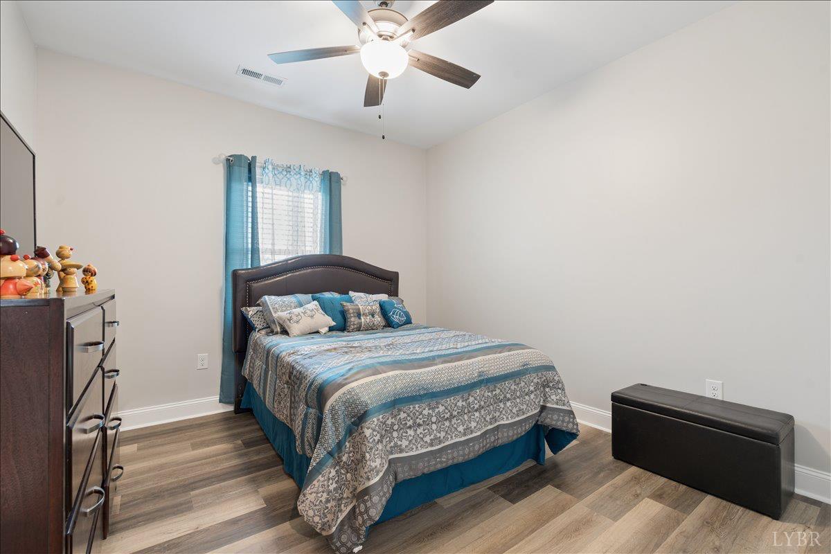 578 Collins Ferry Road Gladys, VA 24554 - Photo 15 of 36 a bedroom with a bed and wooden floor