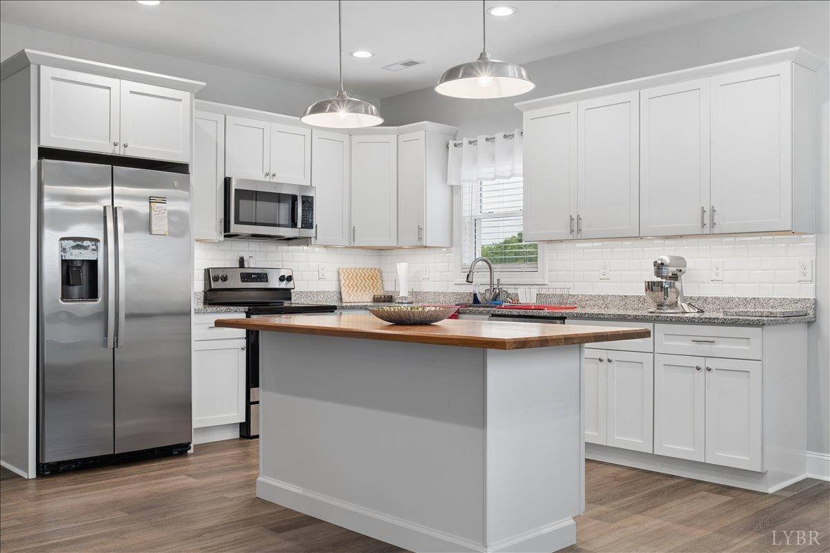 578 Collins Ferry Road Gladys, VA 24554 - Photo 7 of 36 a kitchen with kitchen island granite countertop a sink stainless steel appliances and counter space