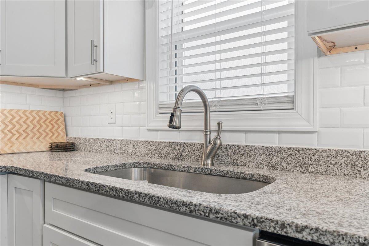 578 Collins Ferry Road Gladys, VA 24554 - Photo 9 of 36 a close view of a sink and a granite counter top a sink