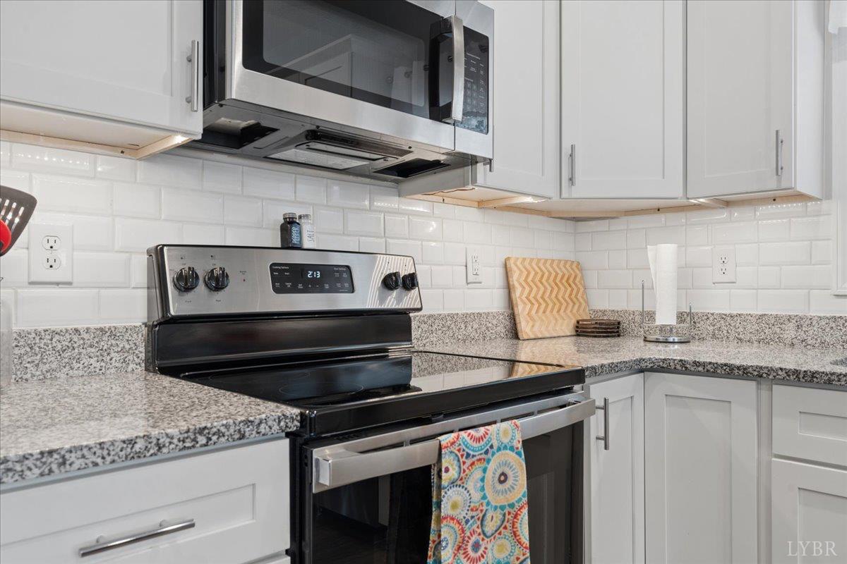 578 Collins Ferry Road Gladys, VA 24554 - Photo 10 of 36 a kitchen with stainless steel appliances granite countertop a stove and a microwave
