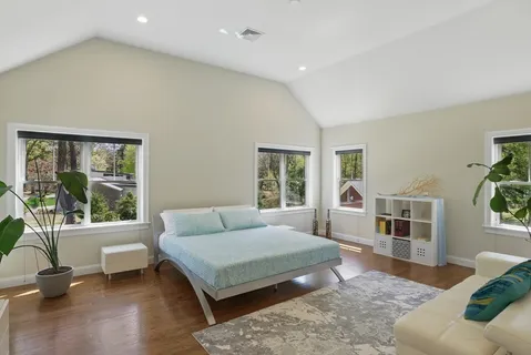 a bedroom with a bed and glass window