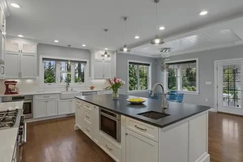 a kitchen with counter space appliances and windows