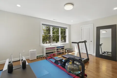 a living room with furniture and a wooden floor